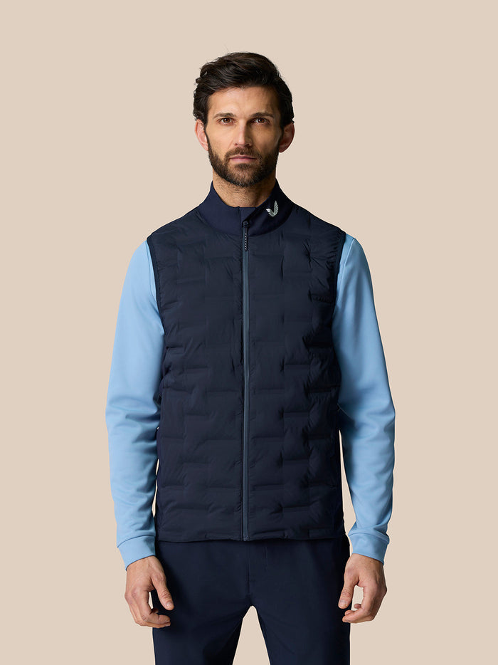 Male model wearing navy Pinnacle Gilet with light blue sleeves and full front zip