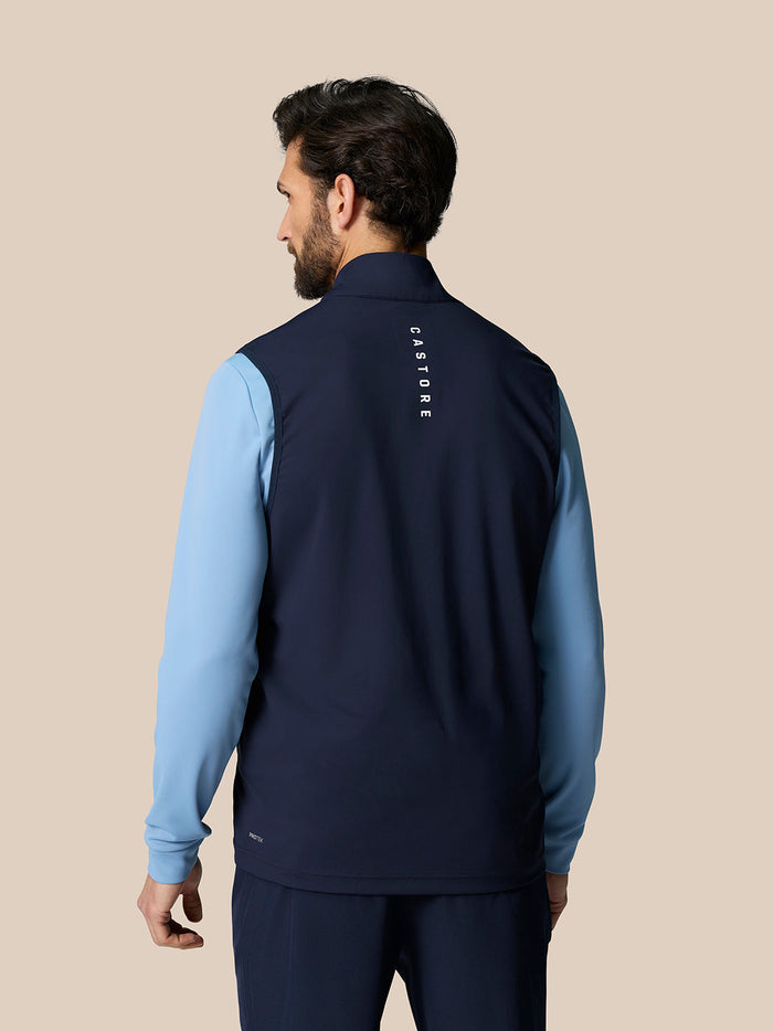 Back view of a man wearing the Pinnacle Gilet with Castore branding down the upper back