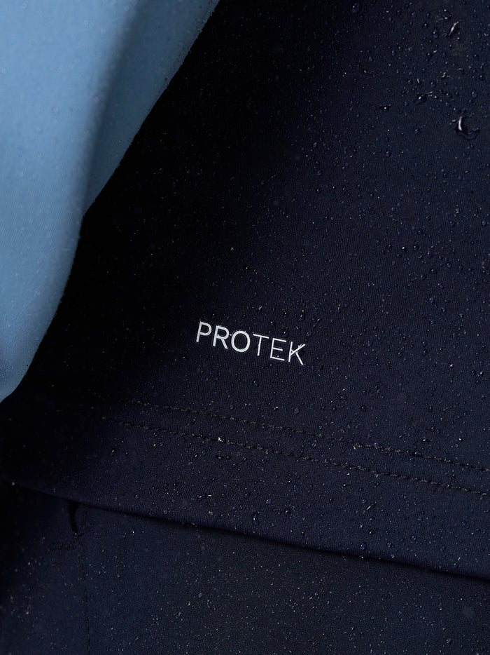 Protek branding on navy Pinnacle Gilet highlighting water resistant finish.