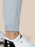 Close-up of lower leg showing ankle hem zip closure on light grey Golf Pinnacle trousers