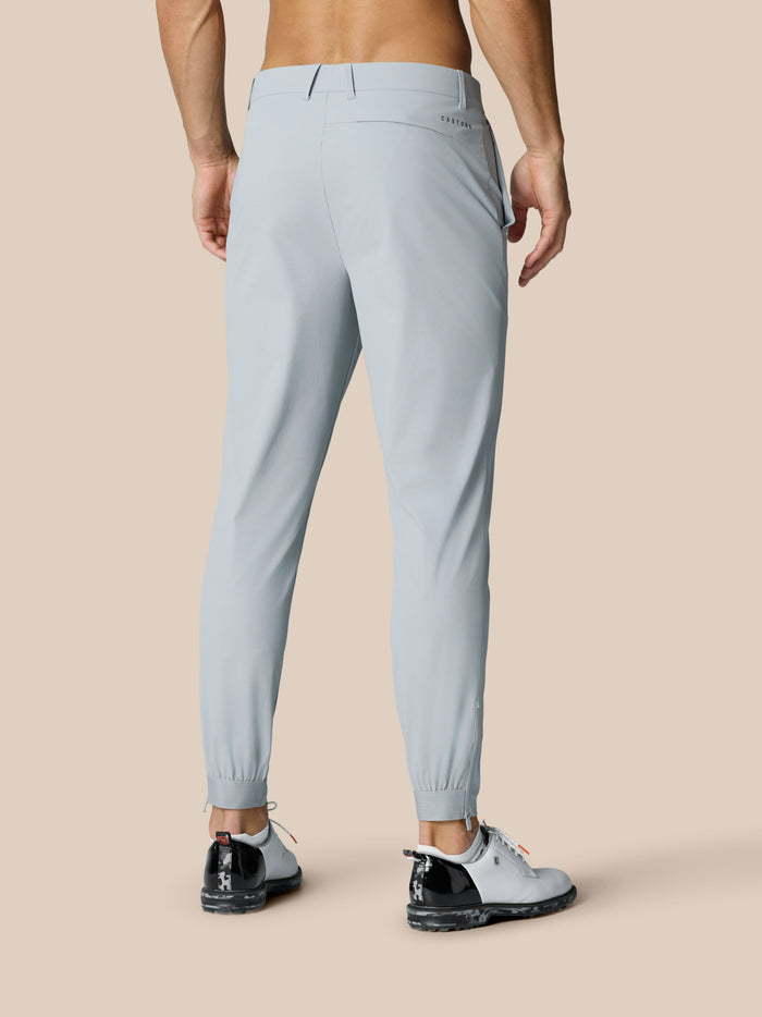 Back view of light grey Golf Pinnacle 32 trousers showing logo near hip and zip cuffs