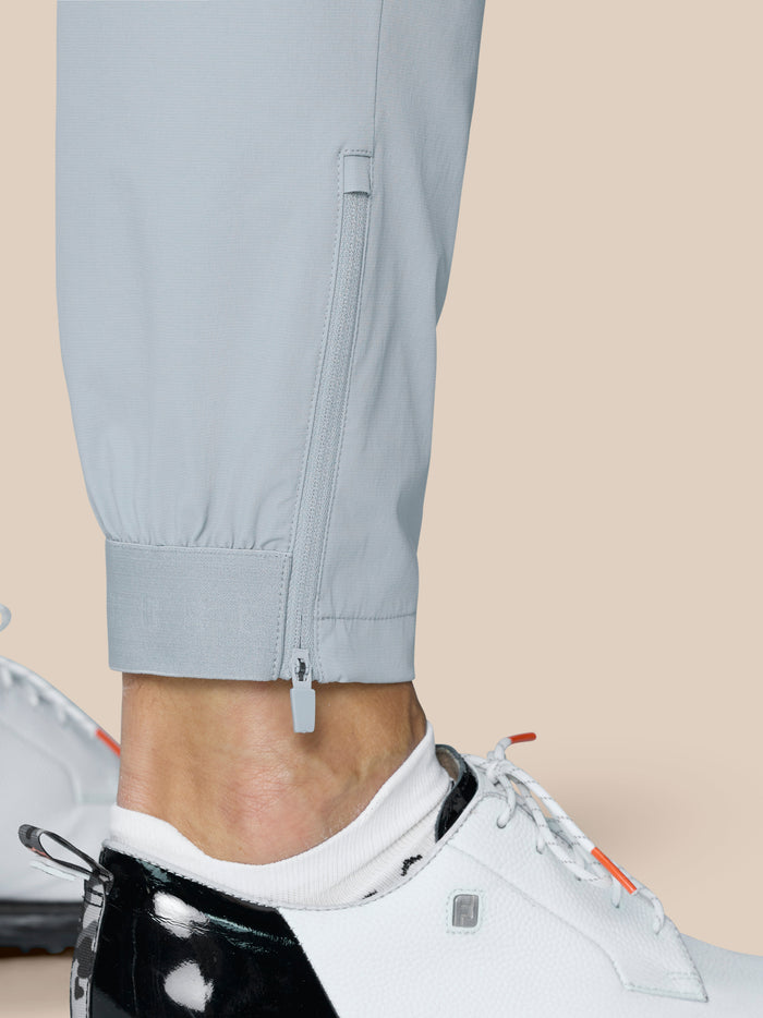 Close up of light grey Castore Golf Pinnacle trouser leg with an ankle zip closure