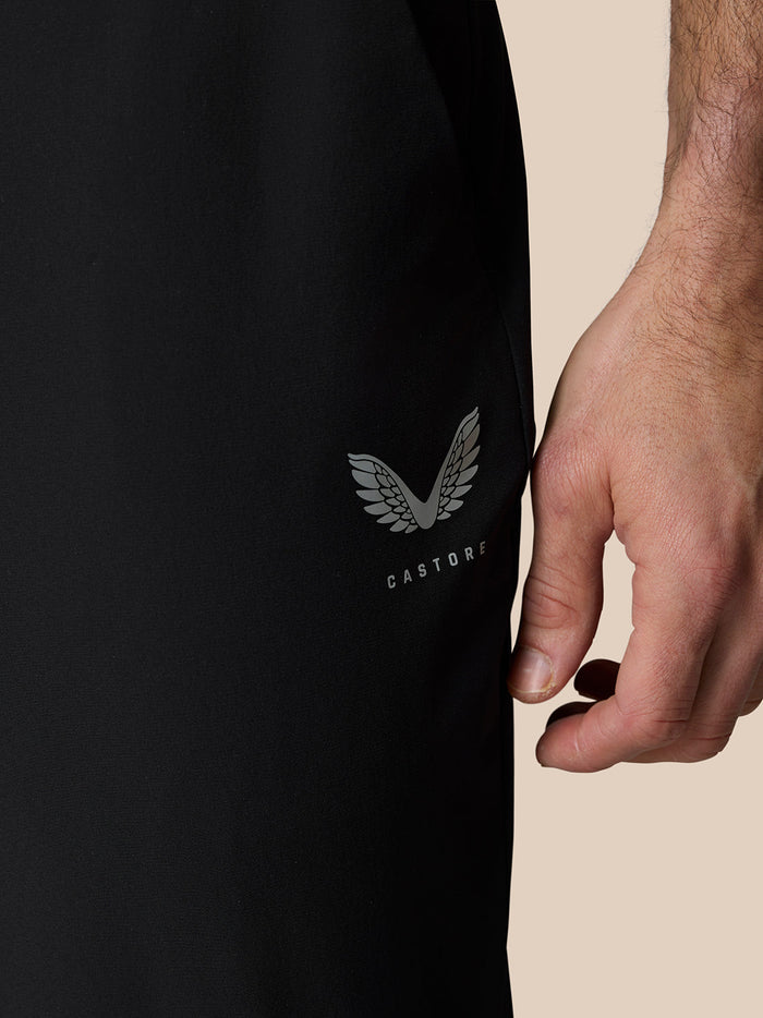Close-up of Castore logo and wing emblem on black Golf Pinnacle trousers at the thigh