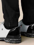 Close-up of Golf Pinnacle 32 trousers lower leg with inseam zip closures and a visible Castore logo on the thigh