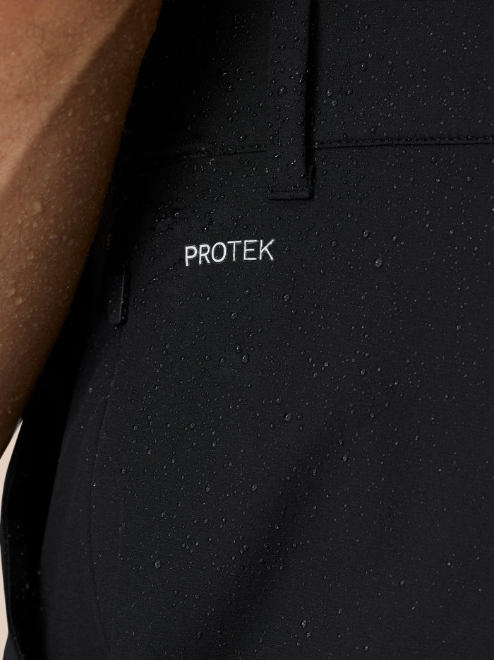 Detail of ProTek fabric and cuff zipper on black Golf Pinnacle trousers.