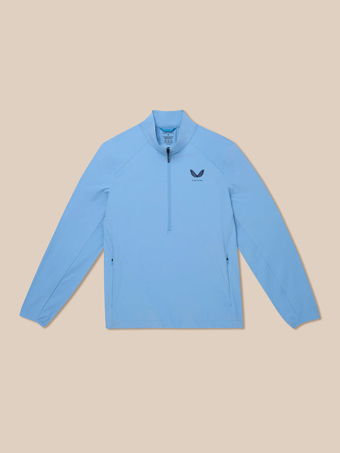 Front view of a sky blue Golf Flex Jacket laid flat, showing a half-zip collar and chest logo.