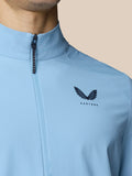 Close-up of sky blue Golf Flex Jacket with front zipper and Castore logo on the left chest.