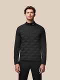 Male model wearing black Golf Pinnacle Jacket with quilted front panels and stand collar