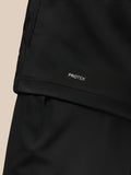 PROTEK branding on the lower hem of the black Golf Pinnacle Jacket