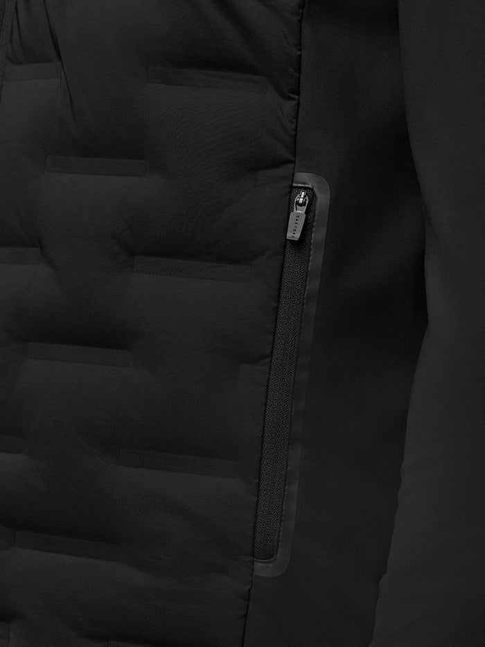 Close up of the Golf Pinnacle Jacket front showing the zipper and quilted panels