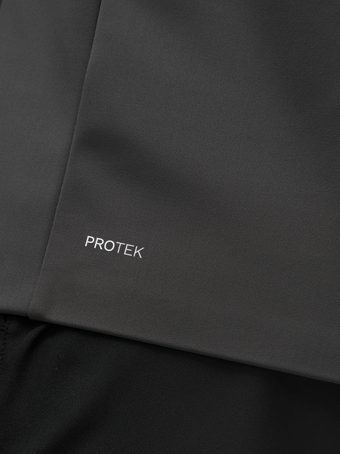 Close up of charcoal Protek fabric with Protek branding on the jacket.