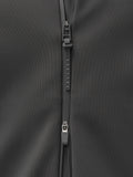 Close up of zipper and seam on dark jacket fabric with CASTORE branding on the zipper pull.