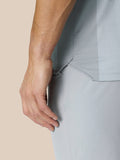 Detail of light grey Pinnacle Golf LVS Polo highlighting side vent panel texture and seam.