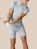 Side view of a male golfer in a light grey Pinnacle Golf LVS Polo while swinging a club