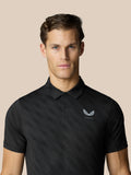 Close up of male model wearing black Club Graphic Polo with small chest logo.