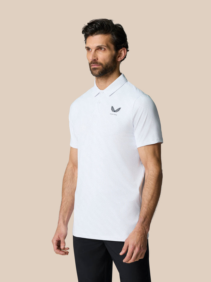 Front view of a man wearing a white golf ball print Club Graphic Polo with left chest logo.