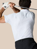 Back view of a man in a white Club Graphic Polo with golf ball print and Castore branding on the upper back, holding a golf club.