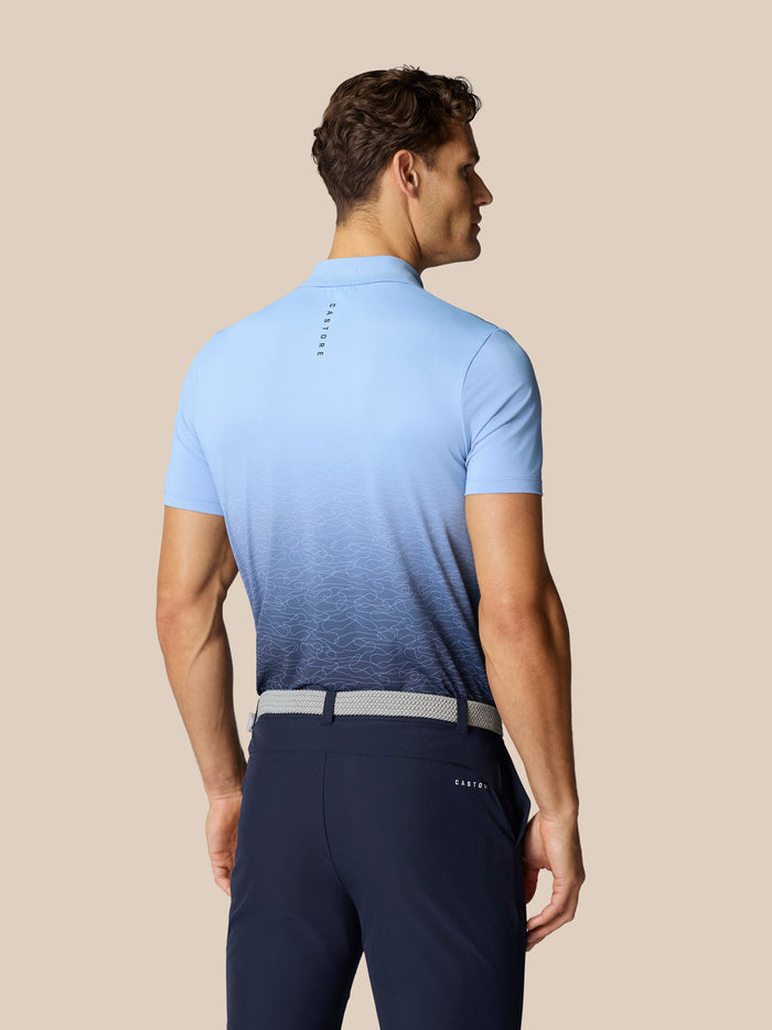Back view of model wearing Club Graphic Polo in sky blue with gradient print and Castore branding on the upper back