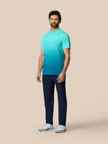 Full-body shot of a man wearing the Club Graphic Polo in a light aqua gradient with navy pants and white golf shoes.