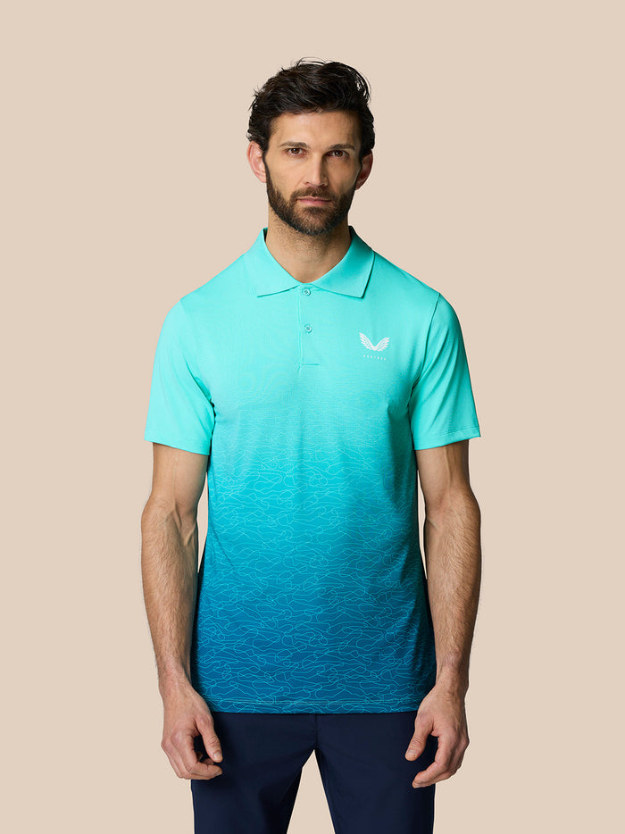 Full front view of a man in a light aqua Club Graphic Polo featuring an ombre lower pattern and Castore logo on the chest