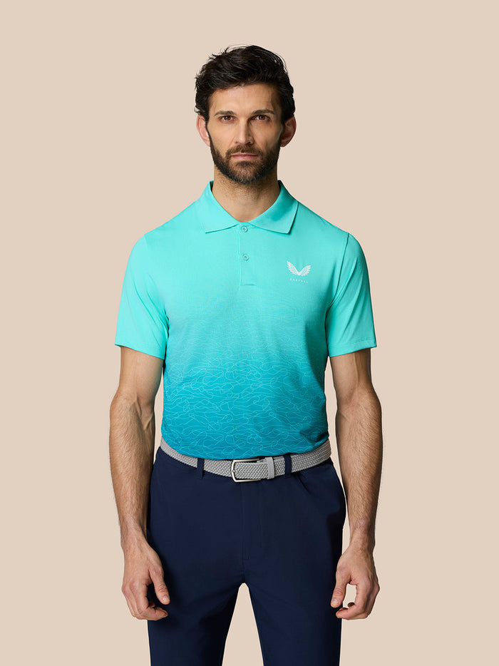 Front view of a model wearing the light aqua Club Graphic Polo with an ombre lower panel and Castore logo on the chest.