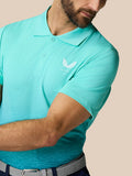 Close-up back detail of the light aqua Club Graphic Polo with a vertical Castore branding along the spine.