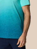Close-up of a model's arm wearing the Club Graphic Polo with short sleeves and teal to aqua ombre print.