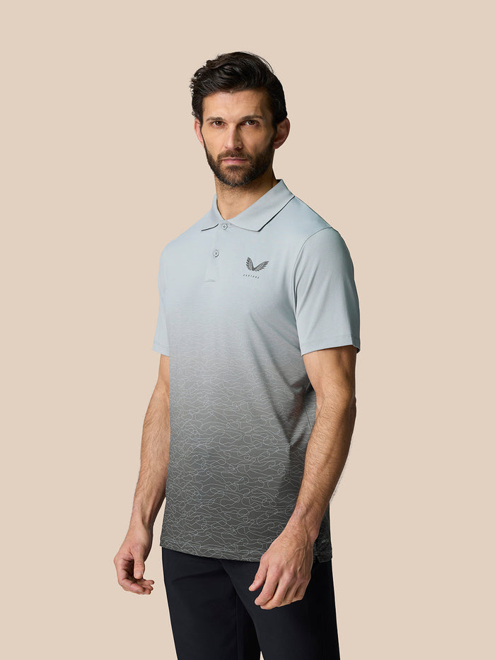 Model wearing Club Graphic Polo Mid Grey with an ombre graphic print and Castore logo on the left chest