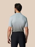 Back view of a man wearing a light grey Club Graphic Polo with an ombre lower panel and Castore branding on the upper back.