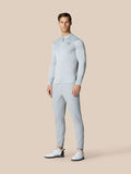 Full body view of a male model in Pinnacle LVS 1/4 Zip Top in Mid Grey with matching pants and white golf shoes.