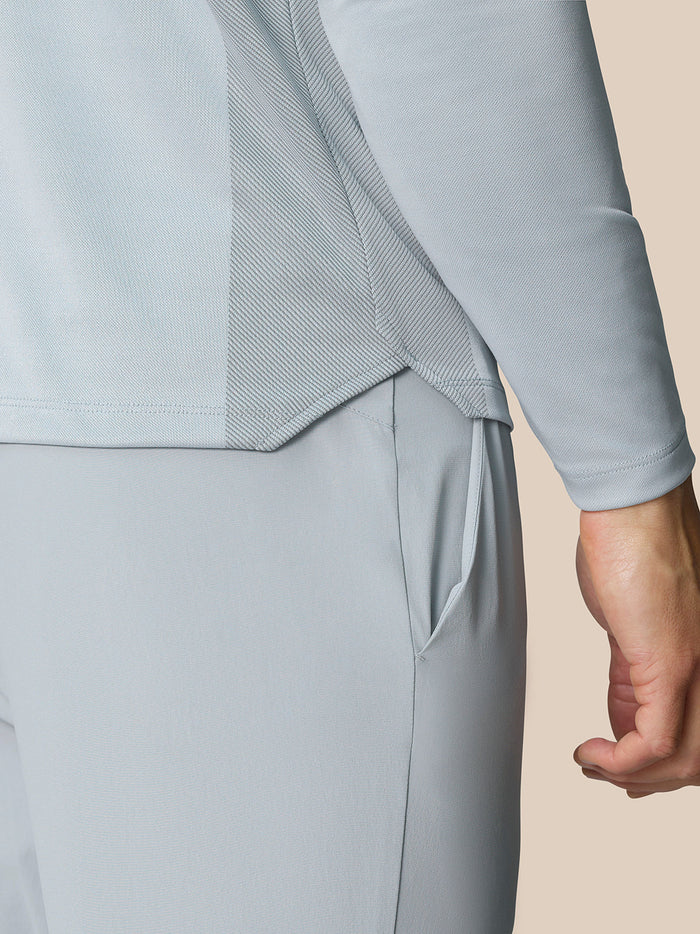 Close-up of the back hip area of the mid grey LVS 1/4 Zip Top with a side pocket and panel detailing.