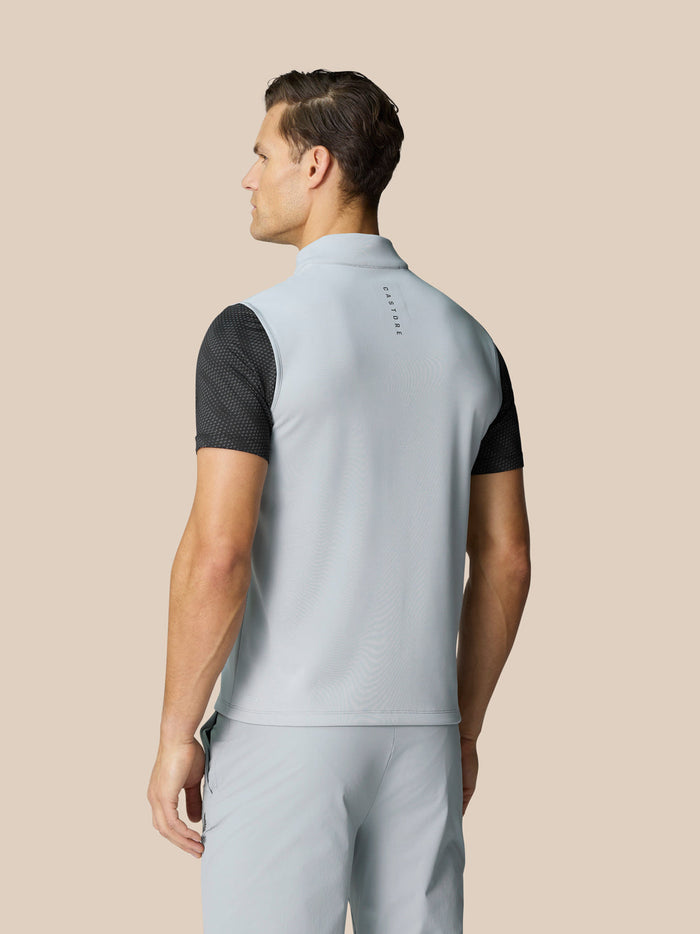Back view of light grey golf gilet showing Castore branding on the upper back