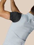 Close up of a male model wearing a light grey Club Classic half zip gilet with a black dotted underarm panel