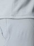 Close-up of light grey ProTek golf gilet fabric with water droplets and clean seam lines