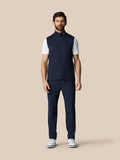Full body shot of male model in navy Club 1/2 Zip Gilet over a white T shirt with navy pants and white shoes