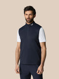 Model wearing navy Club Classic half zip gilet with high neck and sleeveless design; Castore logo at the neckline.