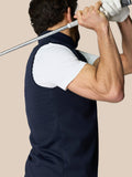 Male model wearing navy Club 1/2 Zip Gilet with high neck and sleeveless design showing Castore branding at the neckline