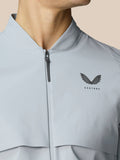 Golf Pinnacle LVS Woven Jacket front view in mid grey with zip collar and Castore logo on chest