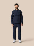 Male model wearing navy Golf Pinnacle LVS Woven Jacket with zip front vented sleeves and white sleeve piping.