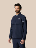 Man wearing midnight navy Golf Pinnacle LVS Woven Jacket with front zipper chest logo and white sleeve piping