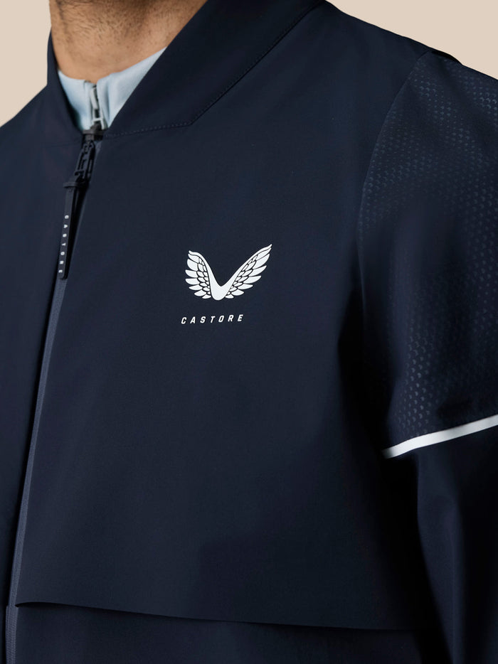 Midnight navy Pinnacle LVS woven golf jacket with white wing Castore logo on chest and zip front