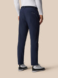Back view of navy golf winter trousers with belt and Castore branding on the rear pocket