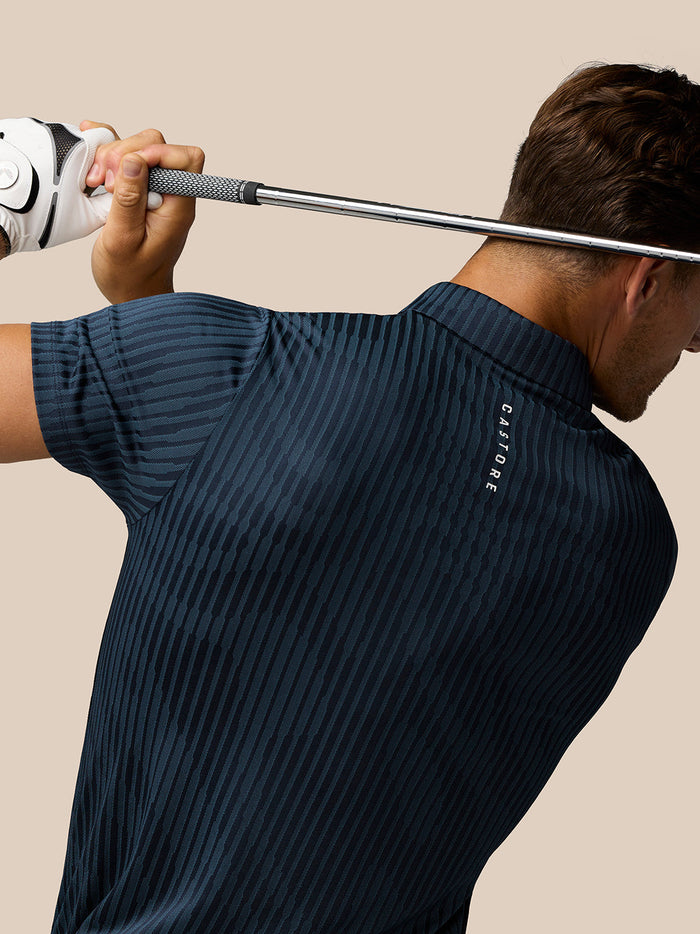Back view of the Midnight Navy polo showing vertical stripes and Castore branding near the neckline.