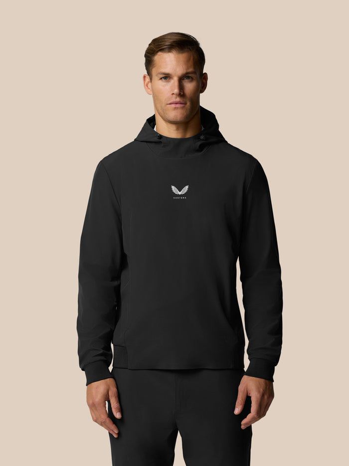 Front view of man in black Golf Pinnacle Performance Hoodie with logo on chest