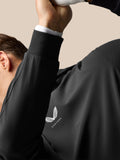 Close-up of white Castore winged logo on the center chest of a black performance hoodie worn by a male model
