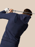 Golf Pinnacle Performance Hoodie in midnight navy worn by a golfer during a swing, highlighting flexible movement panels.
