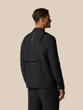 Back view of a man wearing a black Golf Pinnacle LVS Winter Jacket with vertical Castore branding down the back