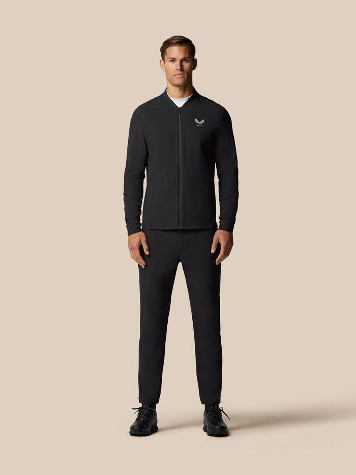 Full-length front view of a man in a black LVS Winter Jacket with center front zip and left chest logo