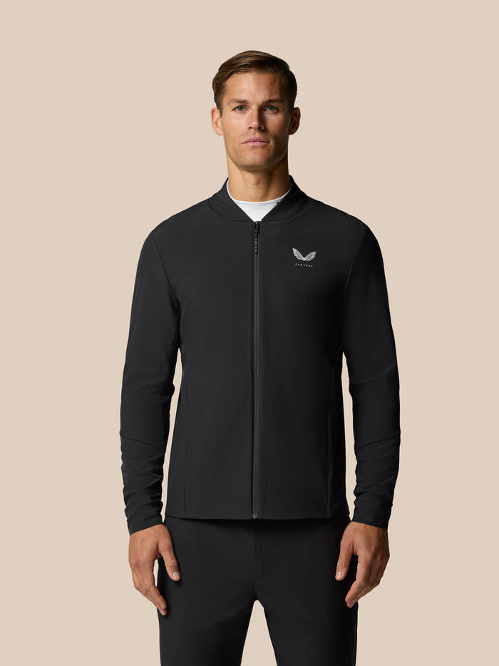 Front view of a man in a black zip bomber jacket with a small left chest logo