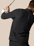 Rear view of a man in a black Castore jacket holding a golf club, showing back vent details and Protek branding.